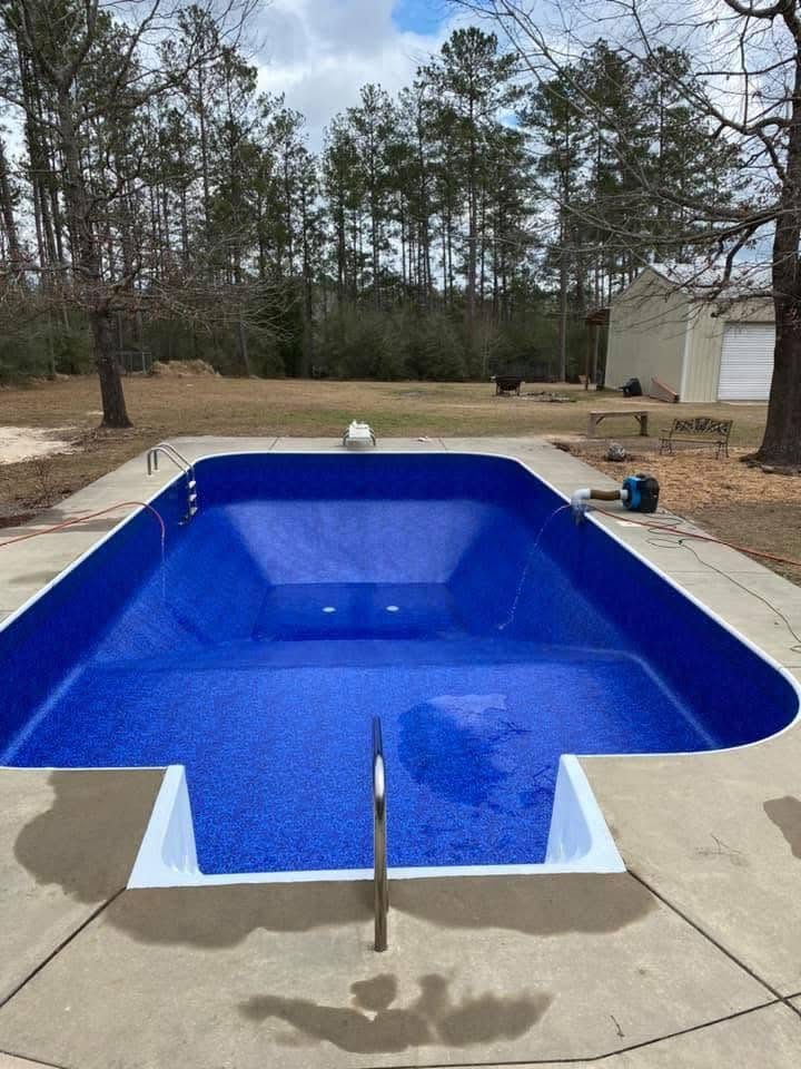 The same pool after a new blue liner was fitted, clean and filling with water